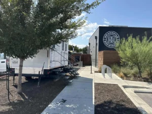 Restroom trailer positioned on a walkway beside an Austin brewery taproom